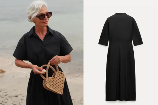 Femme élégante portant une robe noire et tenant un sac en forme de cœur sur une plage.